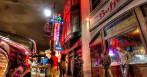 The neon lit facade of the Missouri House building on East 6th Street in Austin