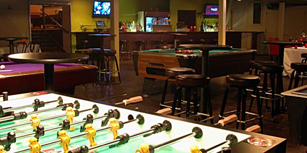 Foosball tables, pool tables and bar stools in the Buffalo Billiards rec room